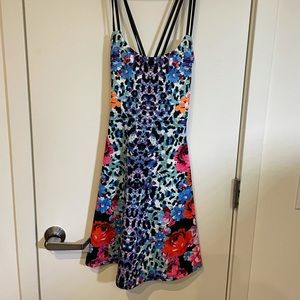 Colorful leopard dress with criss cross straps. Stretchy material & pockets!